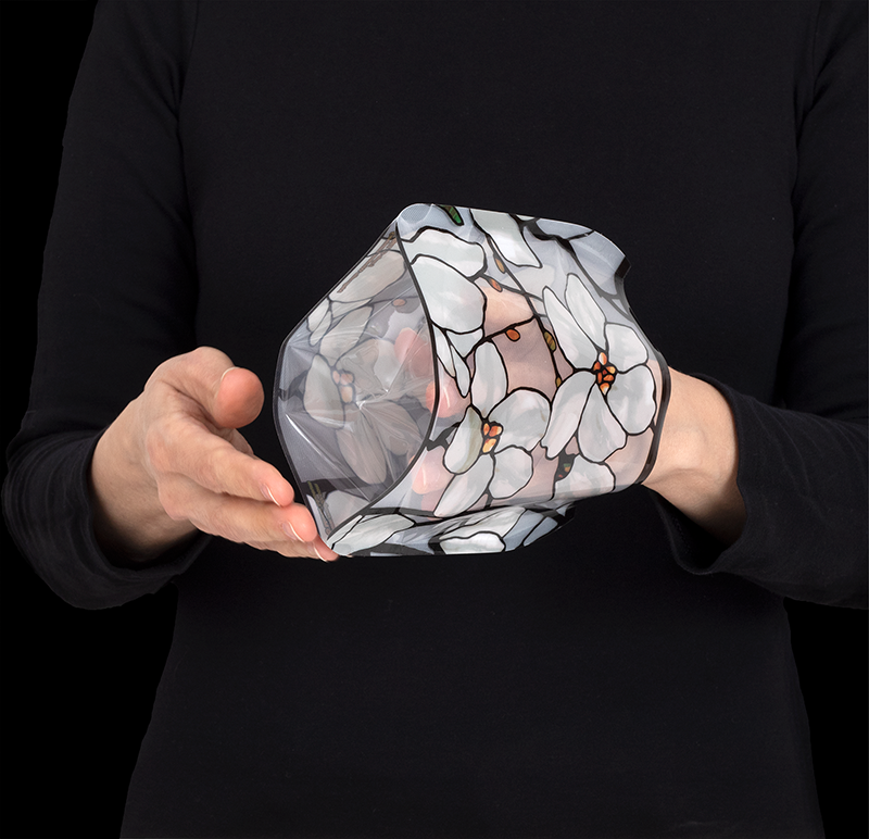 Expand by pushing fingers and thumb against opposite sides of luminary until bottom pops open